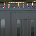 golden-door-toran-with-pom-poms-bells